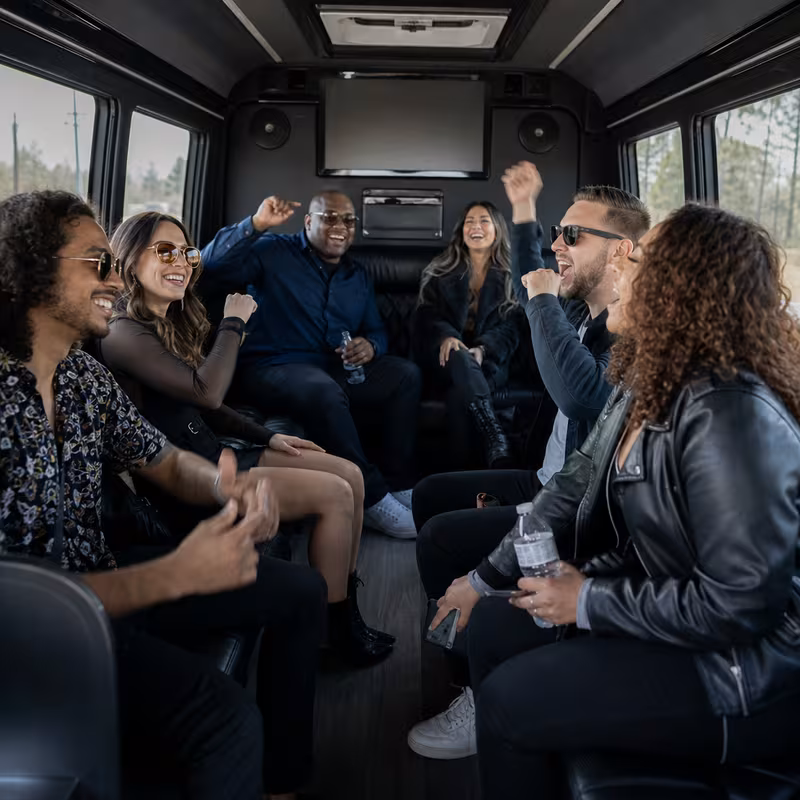 Group boarding a white charter bus for Concert Transportation transportation in Oxnard