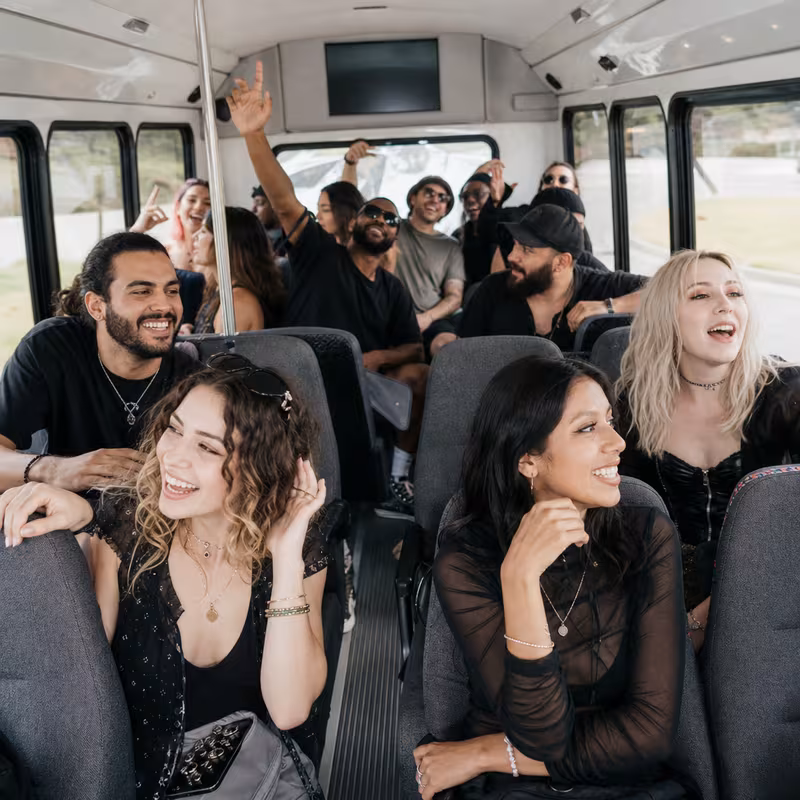Party bus interior with wraparound leather seating and LED lighting in Oxnard