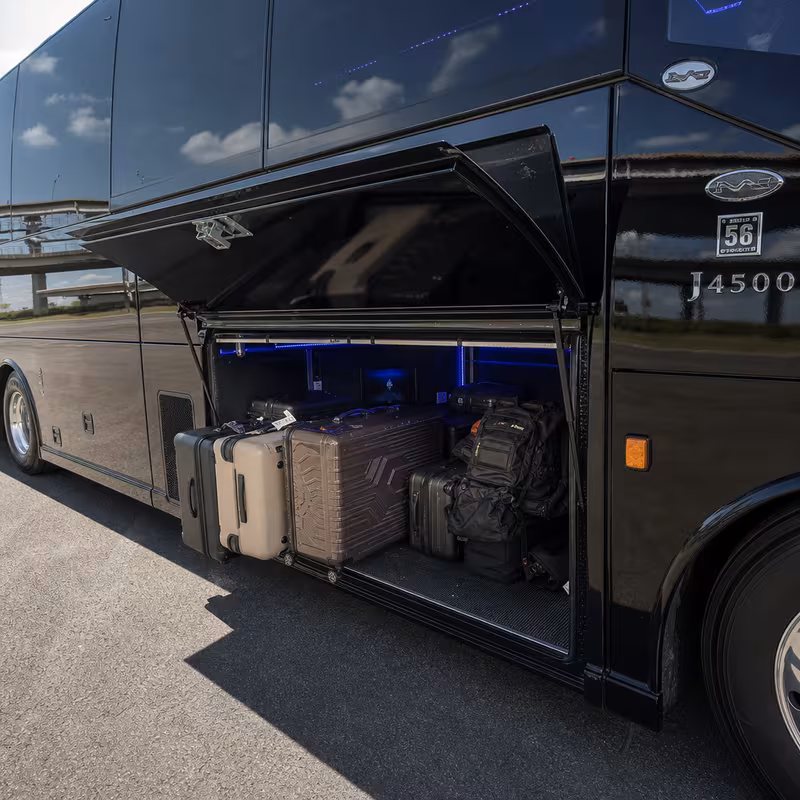Party bus interior with wraparound leather seating and LED lighting in Oxnard