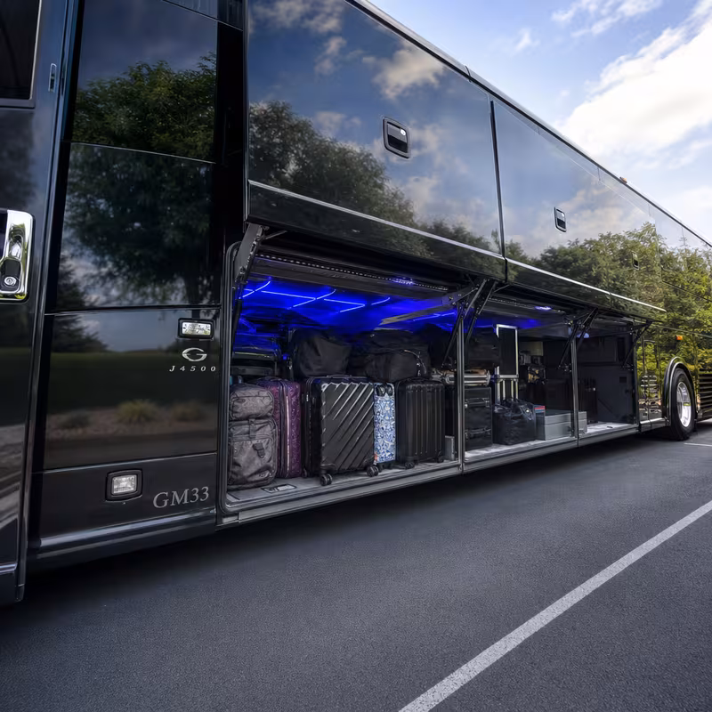 Party bus interior with wraparound leather seating and LED lighting in Oxnard