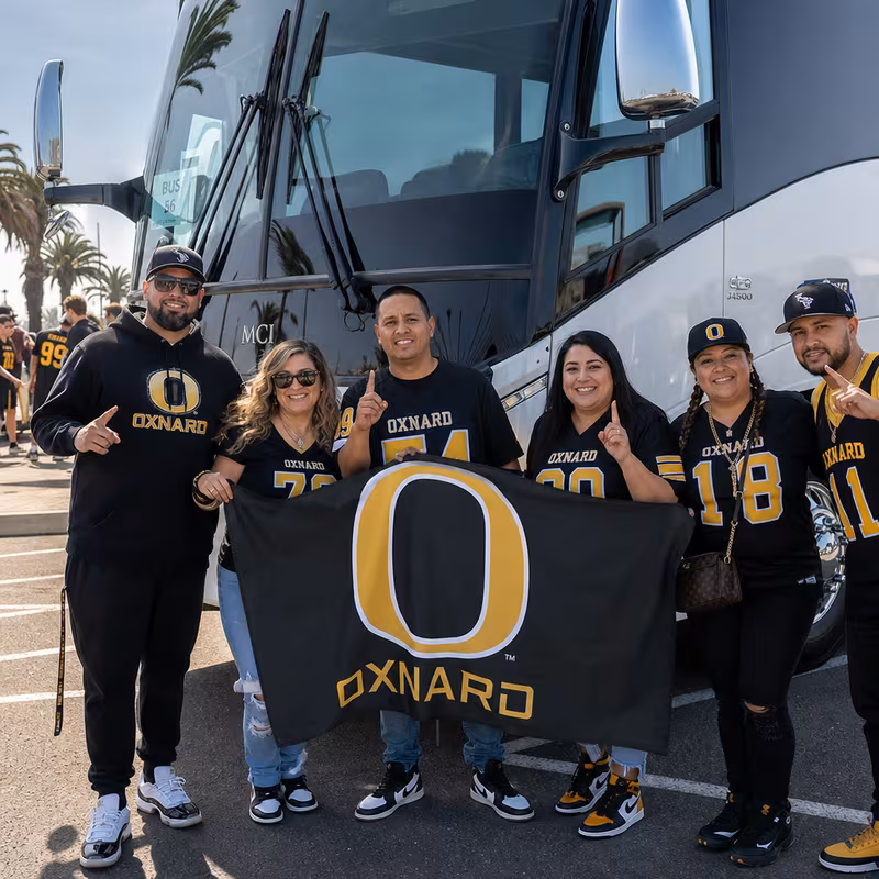 Passengers loading luggage while boarding an Oxnard group shuttle