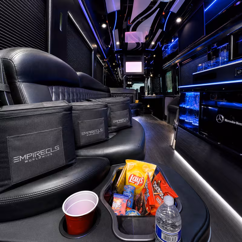 Party bus interior with wraparound leather seating and LED lighting in Oxnard